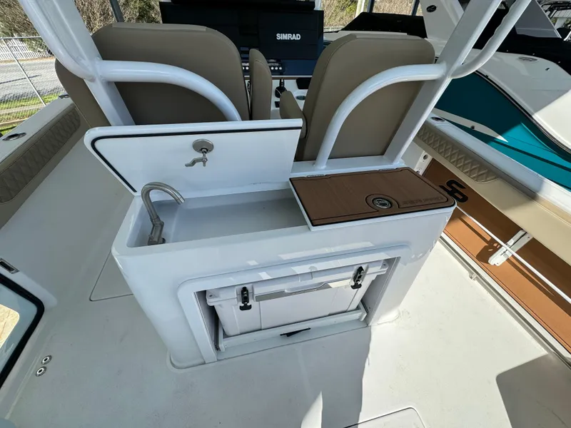 Slide: The Image of 2024 Sea Pro 322 Offshore boat interior with sink and storage. - 19