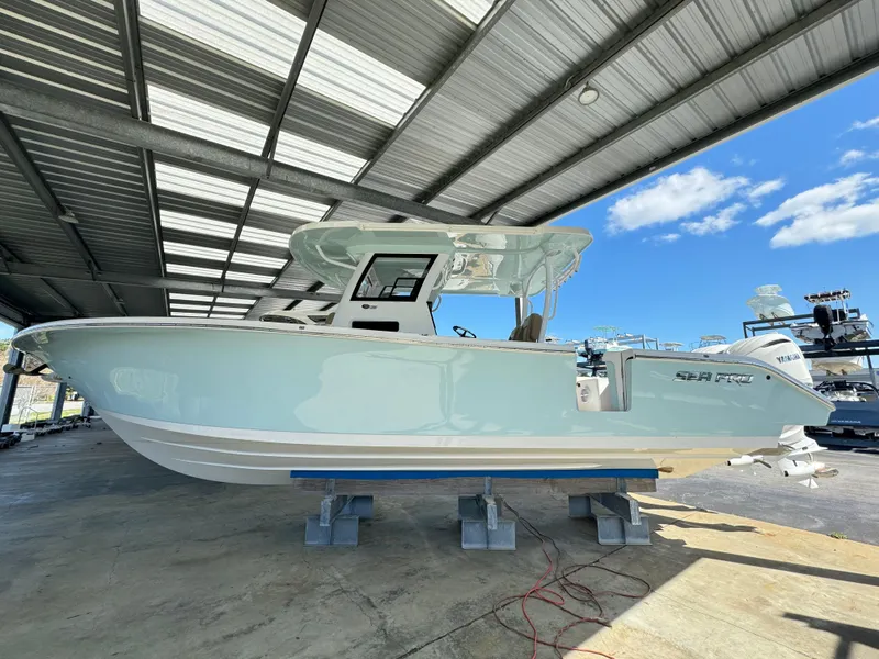 Slide: The Image of 2024 Sea Pro 322 Offshore boat under a metal canopy. - 2