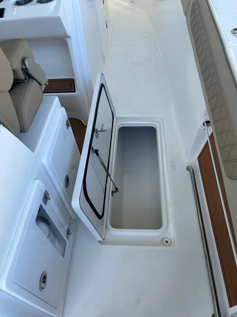 Slide: The Image of 2024 Sea Pro 322 Offshore boat with open storage compartment. - 23