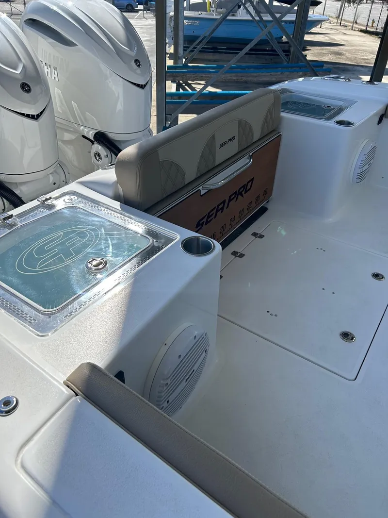 Slide: The Image of 2024 Sea Pro 322 Offshore boat interior with dual engines and seating area. - 26