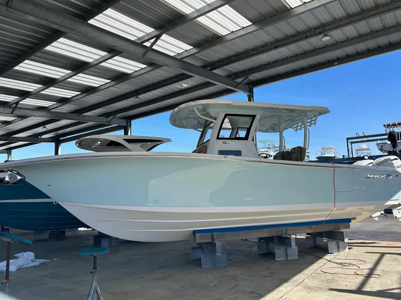 Slide: The Image of 2024 Sea Pro 322 Offshore boat under a covered dock. - 3