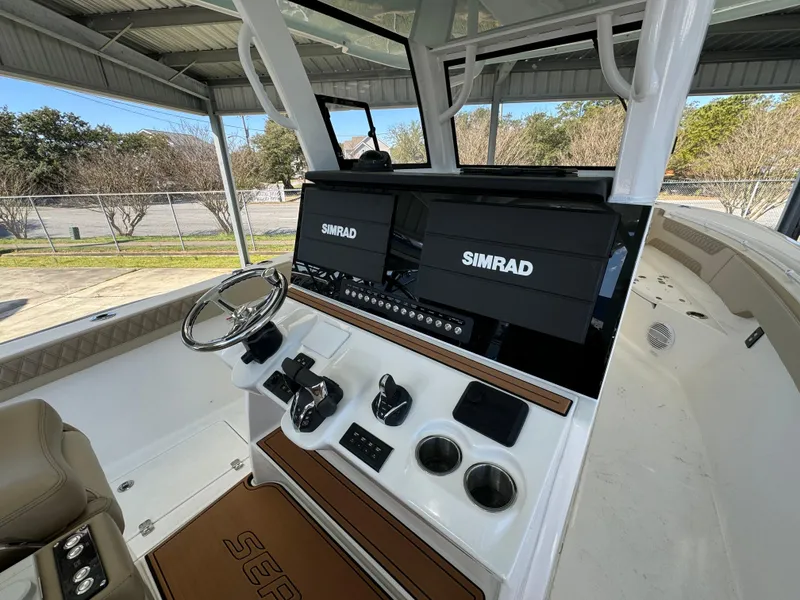 Slide: The Image of 2024 Sea Pro 322 Offshore boat helm with dual Simrad displays. - 33