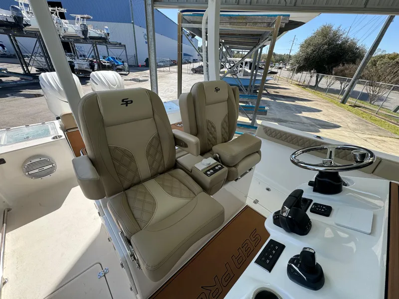 Slide: The Image of 2024 Sea Pro 322 Offshore boat interior with dual captain's chairs and control console. - 34