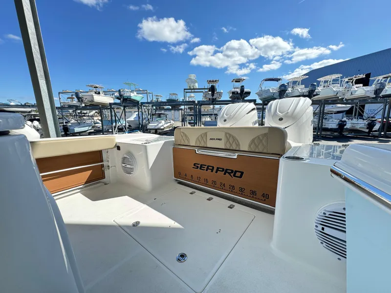 Slide: The Image of 2024 Sea Pro 322 Offshore boat interior with seating and storage. - 5