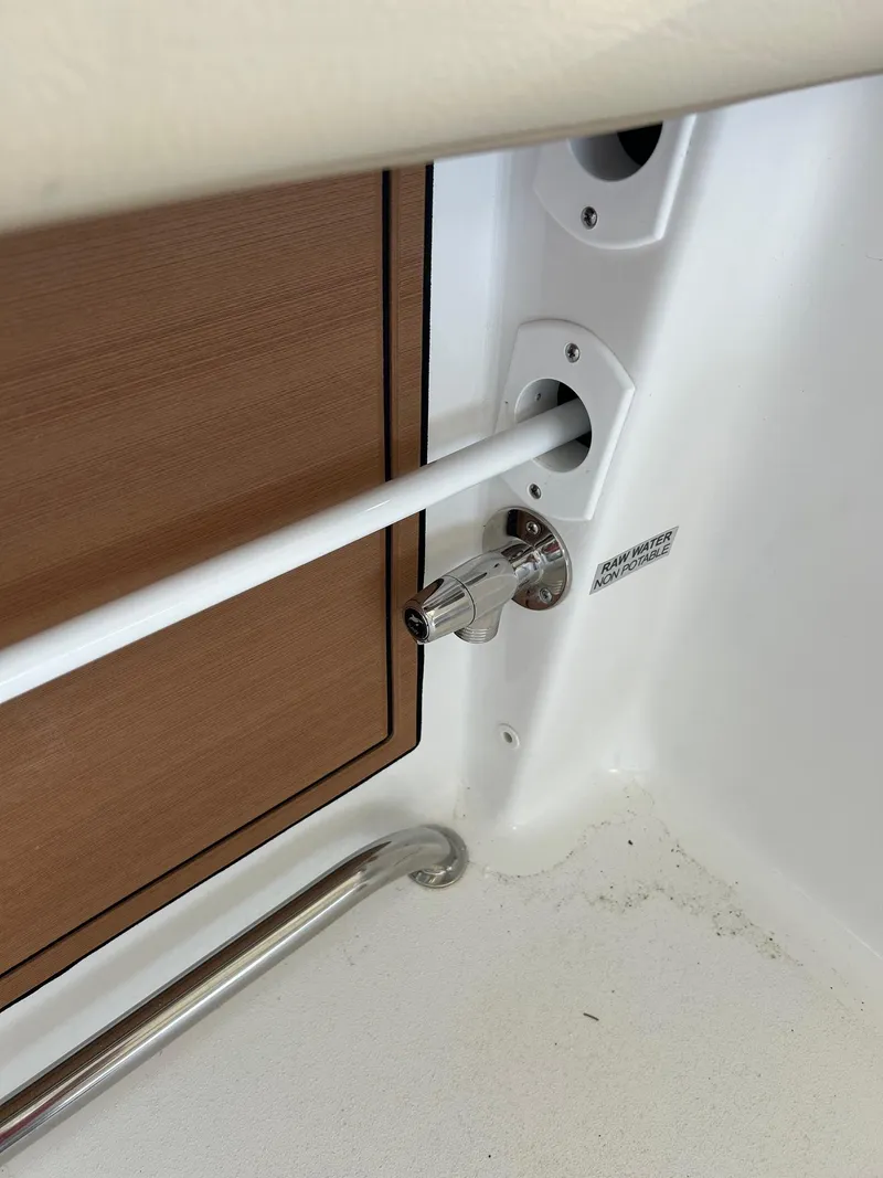 Slide: The Image of 2024 Sea Pro 322 Offshore boat interior detail showing rod holder and storage compartment. - 7