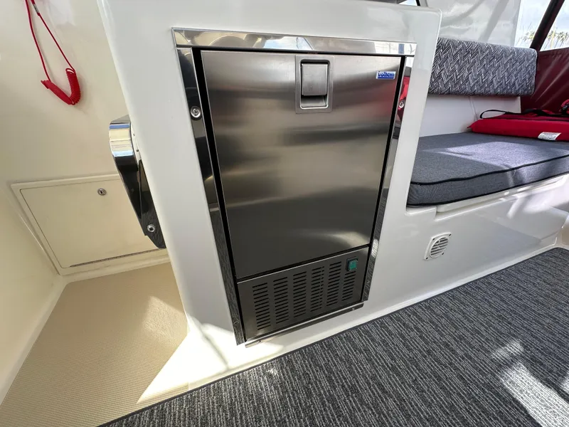 Slide: The Image of Stainless steel refrigerator in 2016 Marlow Pilot 31 boat interior. - 14