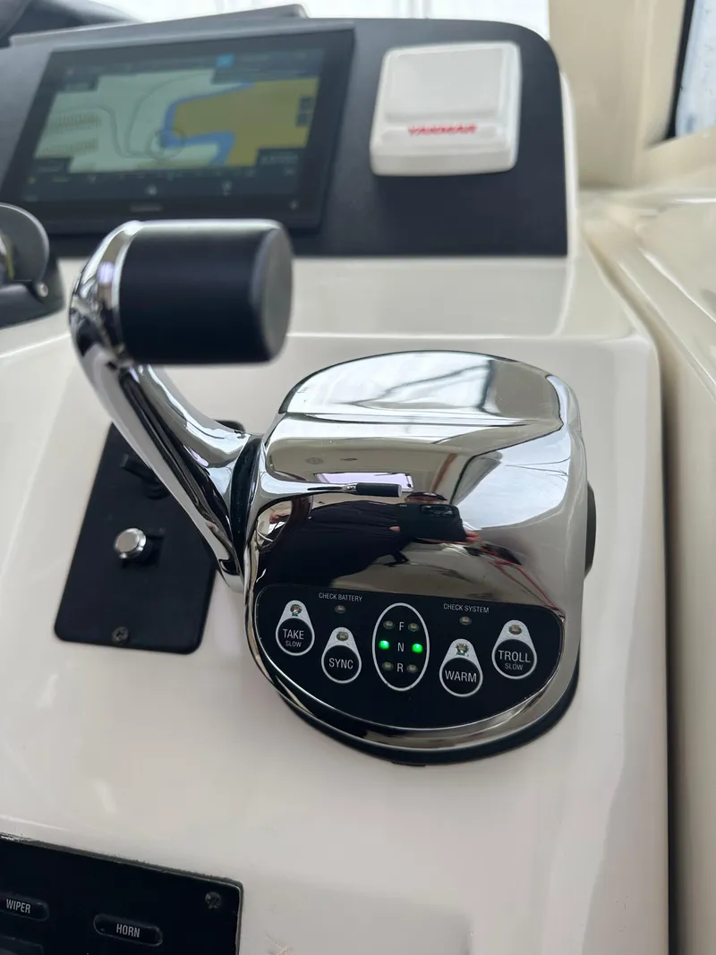 Slide: The Image of Close-up of the control panel and throttle of a 2016 Marlow Pilot 31 boat. - 15