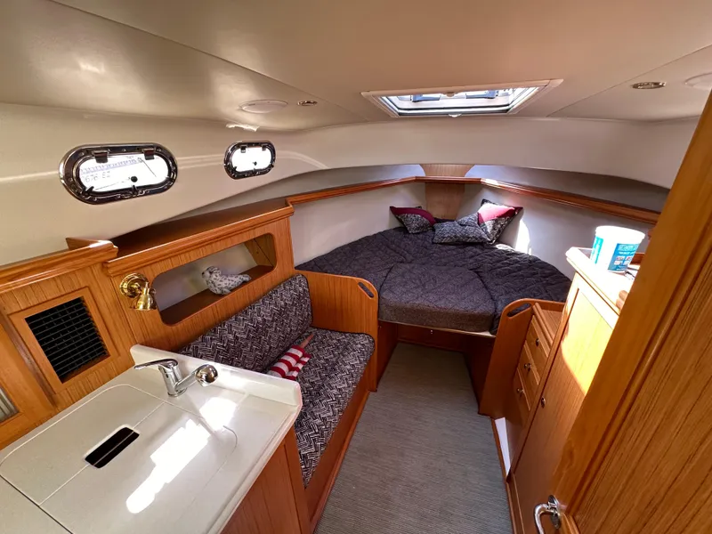 Slide: The Image of Interior cabin of 2016 Marlow Pilot 31 with bed, sink, and seating area. - 20
