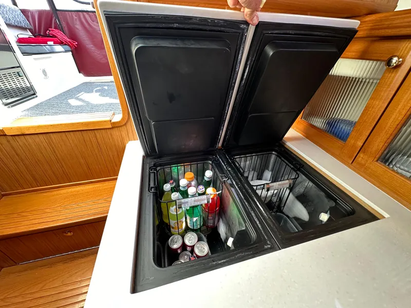 Slide: The Image of Built-in cooler with beverages on a 2016 Marlow Pilot 31 boat. - 23