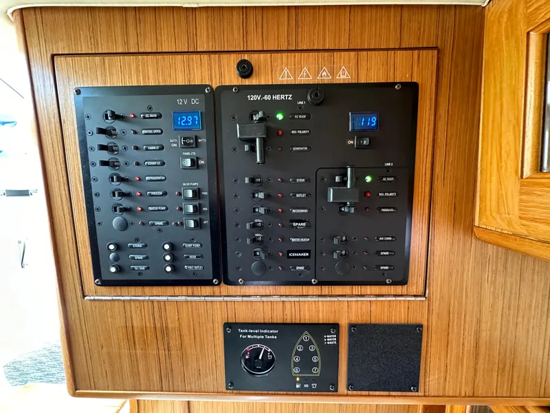 Slide: The Image of Control panel of a 2016 Marlow Pilot 31 boat with various switches and gauges. - 25