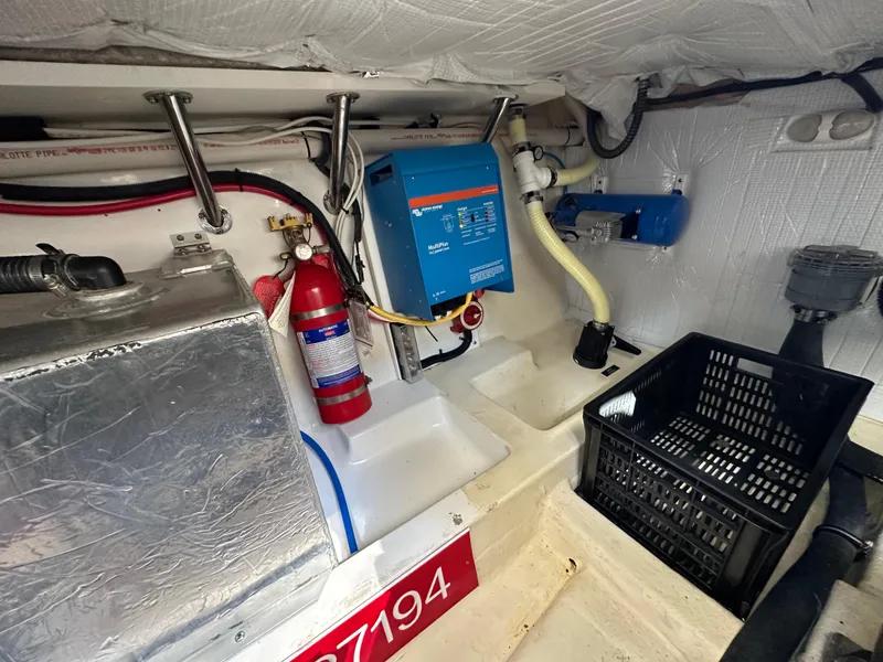Slide: The Image of Engine room of a 2016 Marlow Pilot 31 boat with fire extinguisher and equipment. - 33