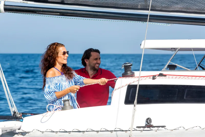 Slide: The Image of Couple sailing on Corsair 760 yacht, enjoying sunny day at sea, 2026 model. - 10