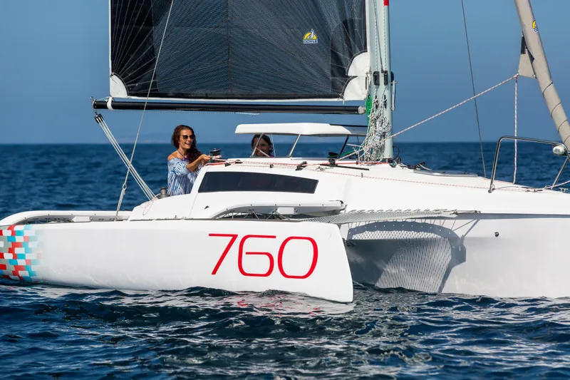Slide: The Image of Sleek 2026 Corsair 760 sailboat on open water, featuring modern design and vibrant graphics. - 11