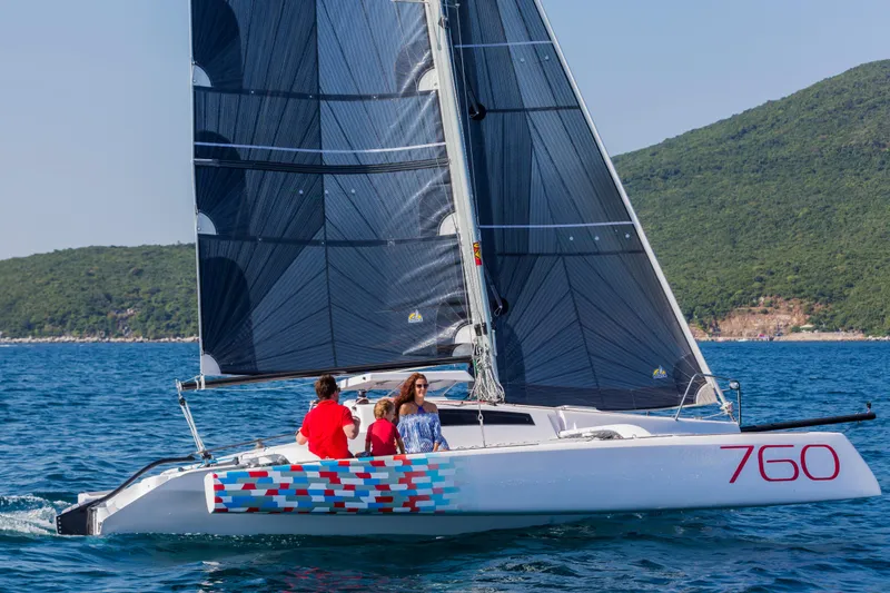Slide: The Image of Sailing on a Corsair 760 trimaran, 2026 model, in clear blue waters. - 17