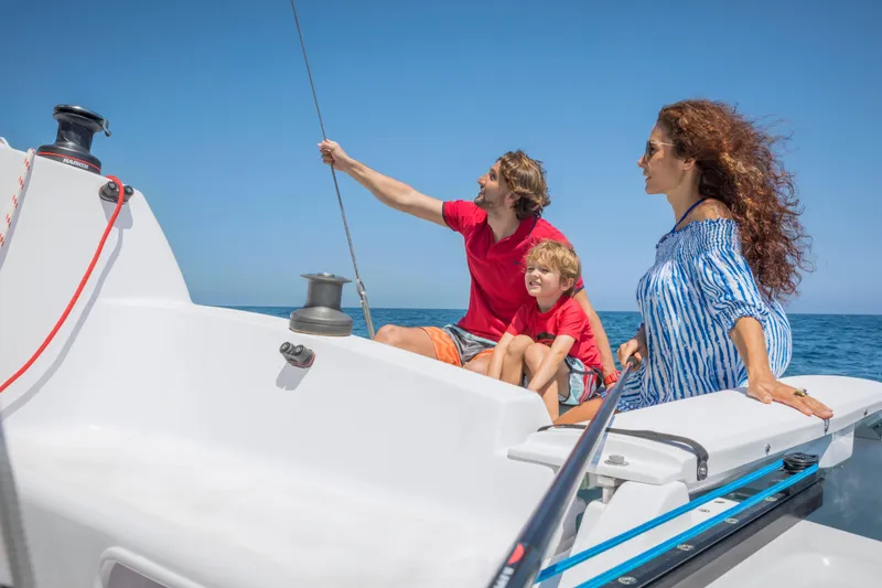 Slide: The Image of Family enjoying a sunny day on a 2026 Corsair 760 sailboat. - 22