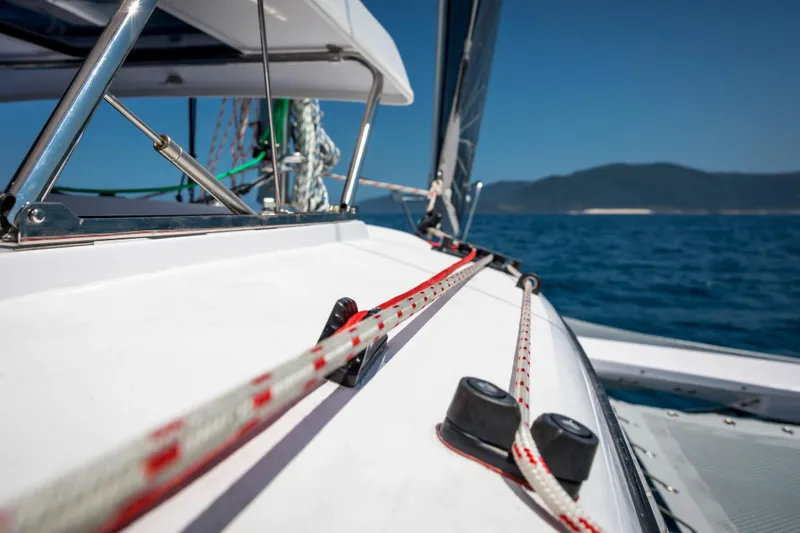 Slide: The Image of Sailing on a 2026 Corsair 760 trimaran, ocean view, clear blue sky. - 27