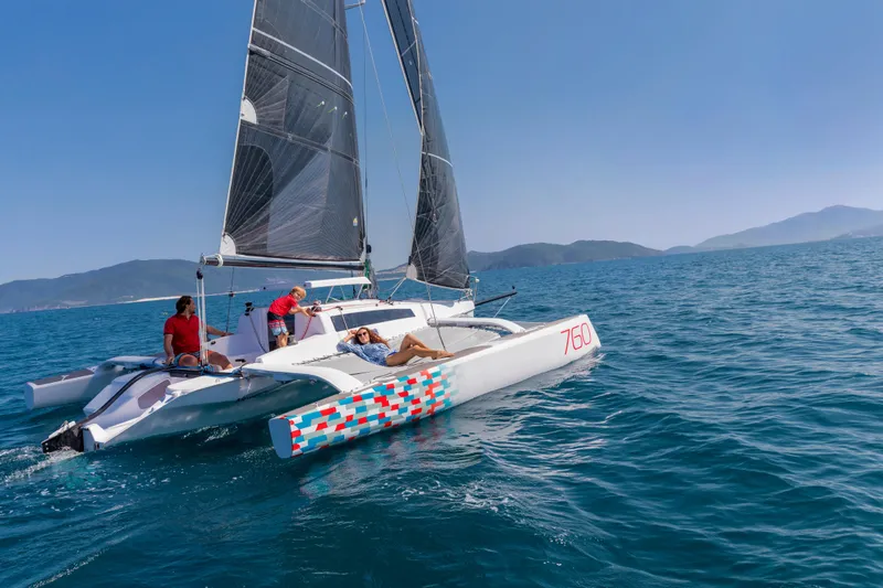 Slide: The Image of Sailing Corsair 760 trimaran on open sea, 2026 model, with crew enjoying sunny day. - 28