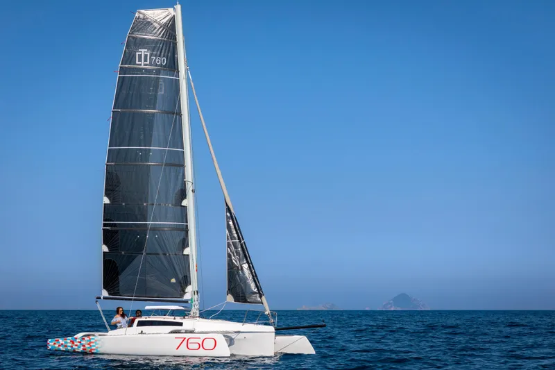 Slide: The Image of Sleek 2026 Corsair 760 sailboat gliding on open sea under clear blue sky. - 31