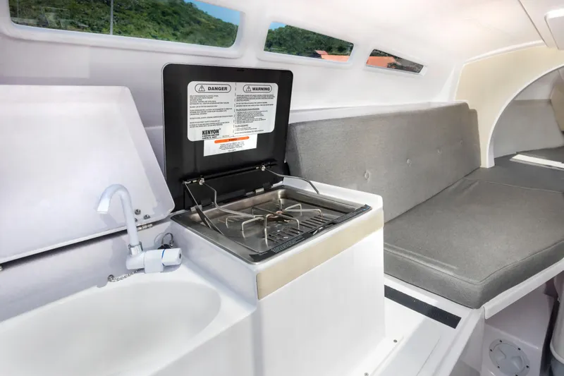 Slide: The Image of Compact interior of 2026 Corsair 760 sailboat with kitchenette and seating area. - 35