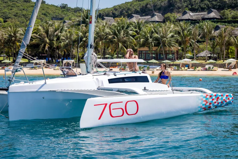 Slide: The Image of Modern Corsair 760 sailboat on water, 2026 model, with people enjoying a sunny day. - 40