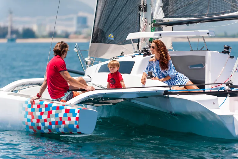 Slide: The Image of Family enjoying a day on a 2026 Corsair 760 sailboat in sunny weather. - 5