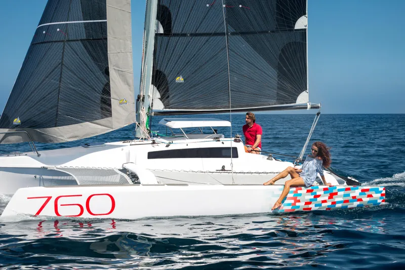 Slide: The Image of Sailing on a 2026 Corsair 760 trimaran, two people enjoy a sunny day at sea. - 9