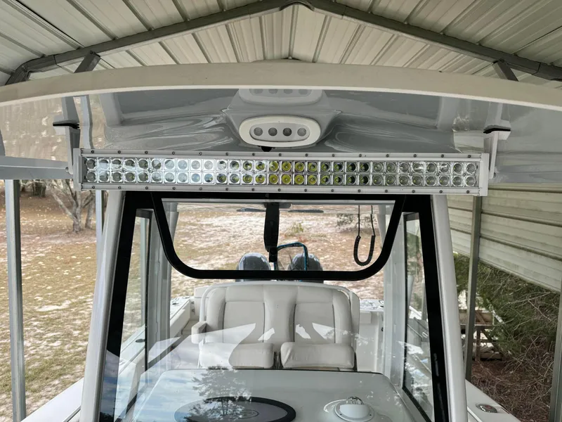 Slide: The Image of 2023 Sea Hunt Gamefish 27 boat under a metal canopy. - 12