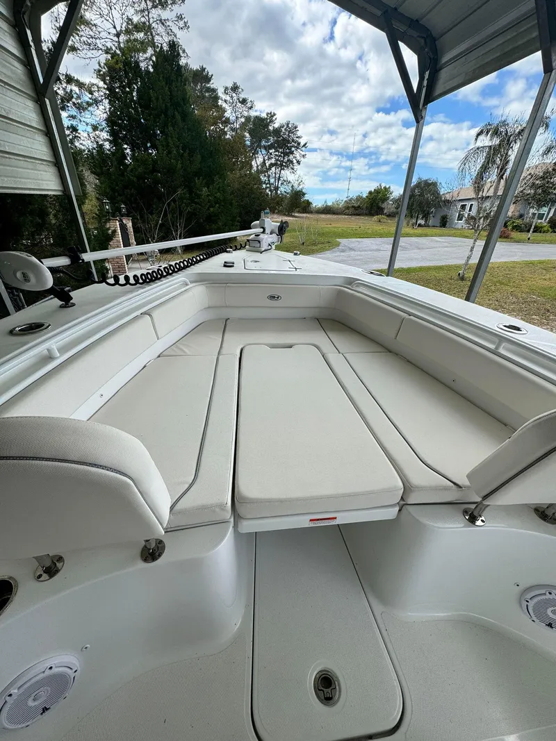Slide: The Image of 2023 Sea Hunt Gamefish 27 boat interior with cushioned seating. - 13