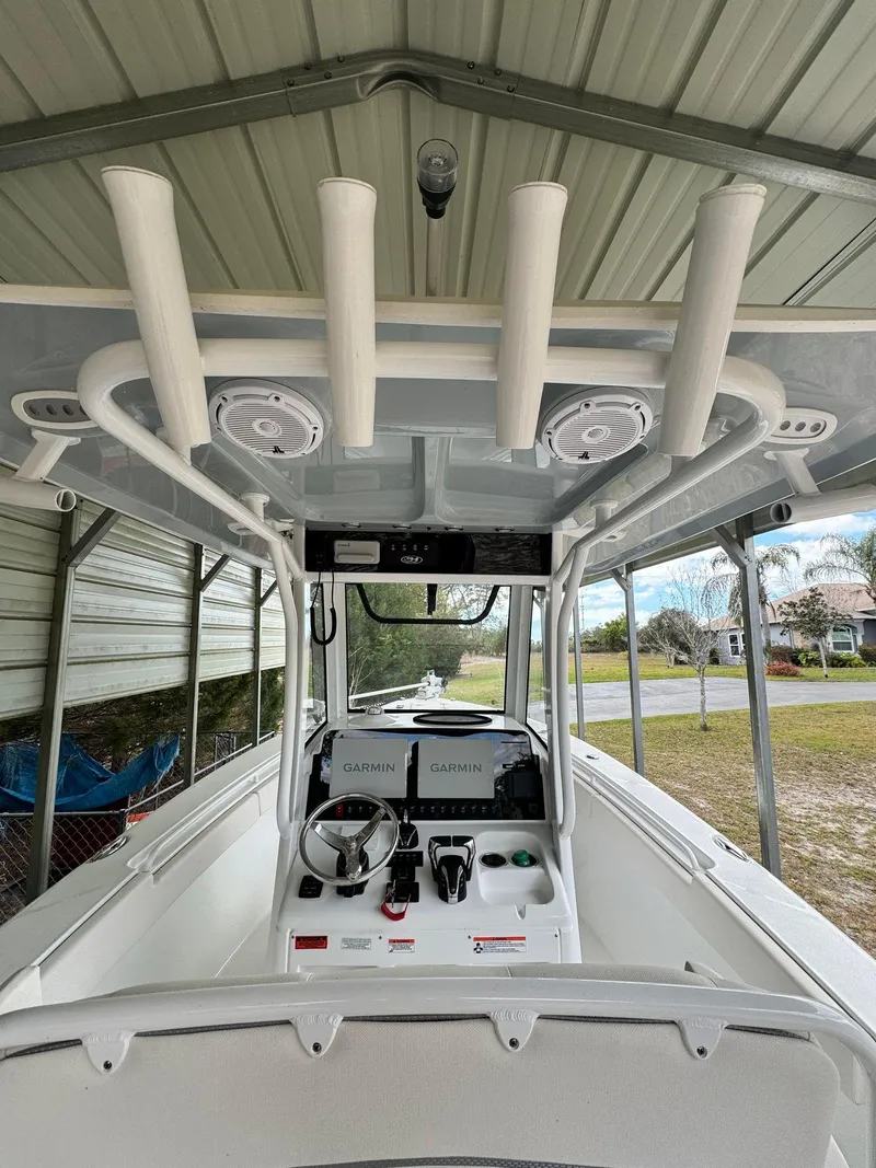 Slide: The Image of 2023 Sea Hunt Gamefish 27 boat console under a covered dock. - 15
