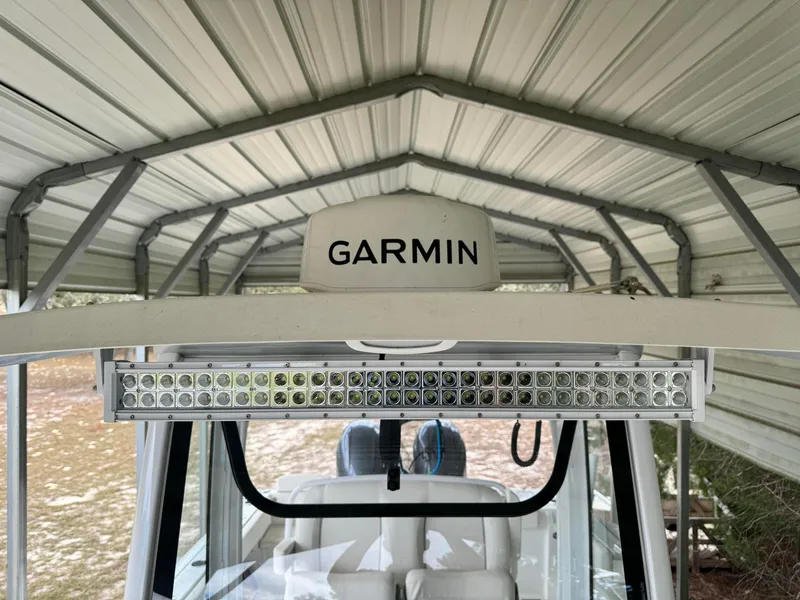 Slide: The Image of 2023 Sea Hunt Gamefish 27 with Garmin equipment under a metal shelter. - 19