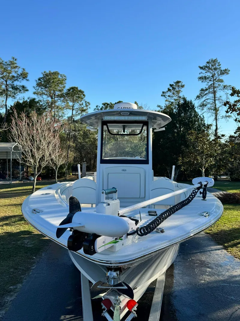 Slide: The Image of 2023 Sea Hunt Gamefish 27 boat on trailer in a wooded area. - 20