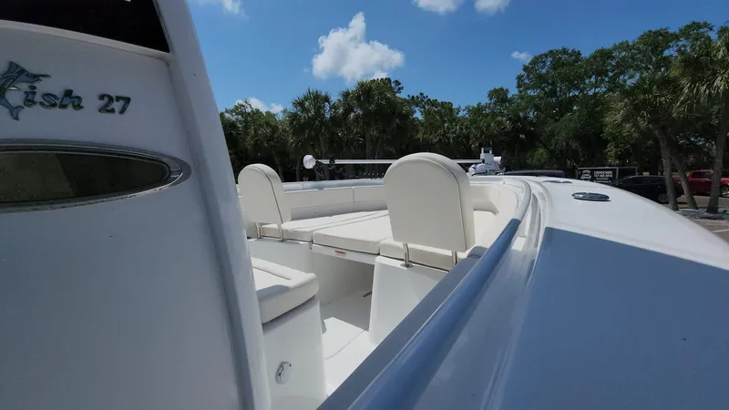 Slide: The Image of 2023 Sea Hunt Gamefish 27 boat interior with seating, clear sky background. - 21