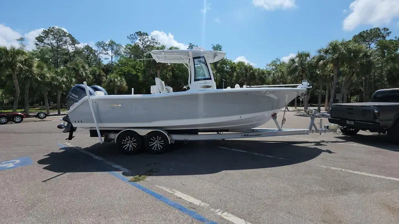 Slide: The Image of 2023 Sea Hunt Gamefish 27 boat on a trailer in a parking lot. - 23