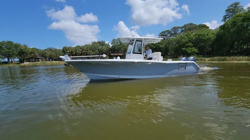Slide: The Image of 2023 Sea Hunt Gamefish 27 boat cruising on a sunny day. - 27