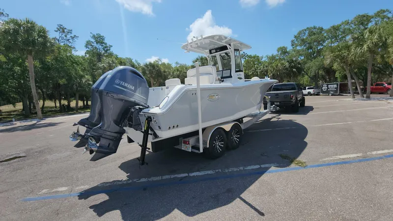 Slide: The Image of 2023 Sea Hunt Gamefish 27 boat on trailer in parking lot. - 28