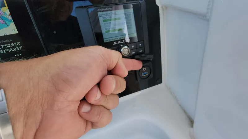 Slide: The Image of Hand operating control panel on 2023 Sea Hunt Gamefish 27 boat. - 30