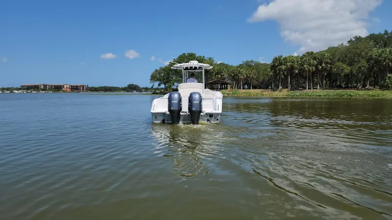 Slide: The Image of 2023 Sea Hunt Gamefish 27 boat cruising on a calm lake. - 35