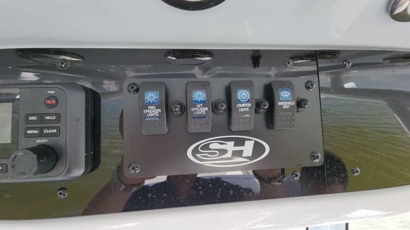 Slide: The Image of Control panel of a 2023 Sea Hunt Gamefish 27 boat with labeled switches. - 38