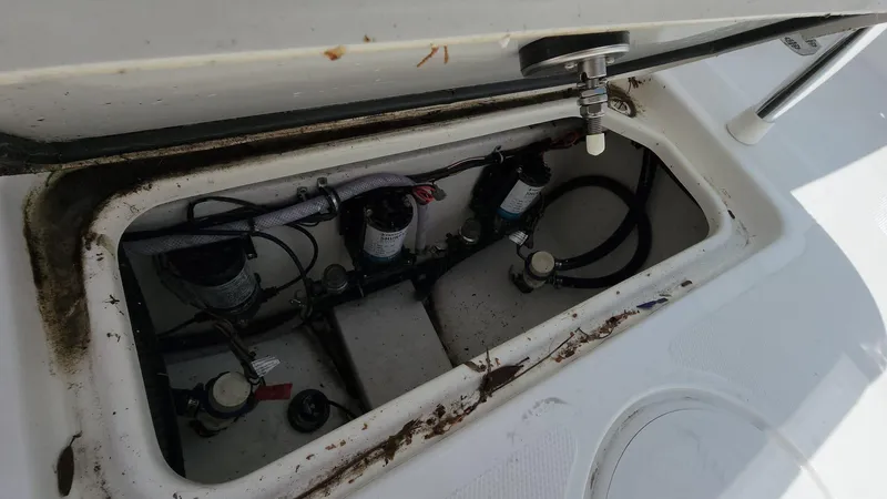 Slide: The Image of 2023 Sea Hunt Gamefish 27 boat storage compartment with pumps and wiring. - 40