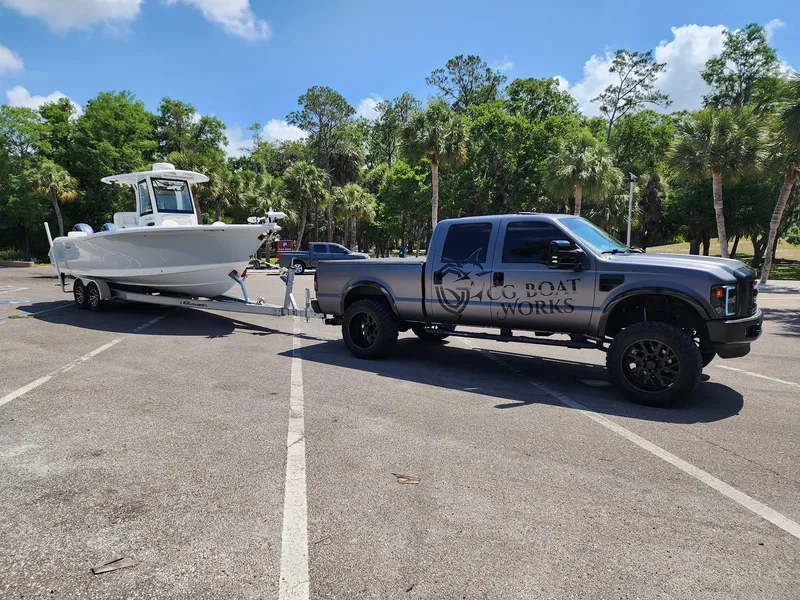 Slide: The Image of 2023 Sea Hunt Gamefish 27 boat towed by truck in parking lot. - 45