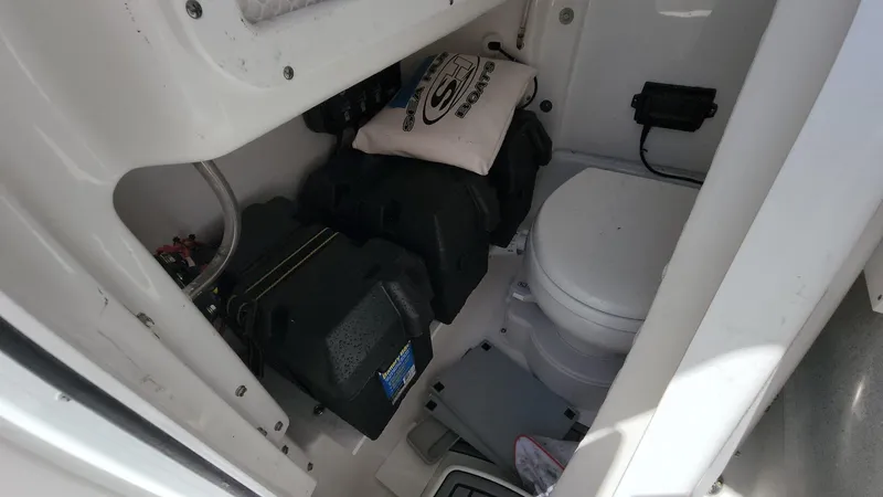 Slide: The Image of 2023 Sea Hunt Gamefish 27 boat interior with toilet and storage area. - 7