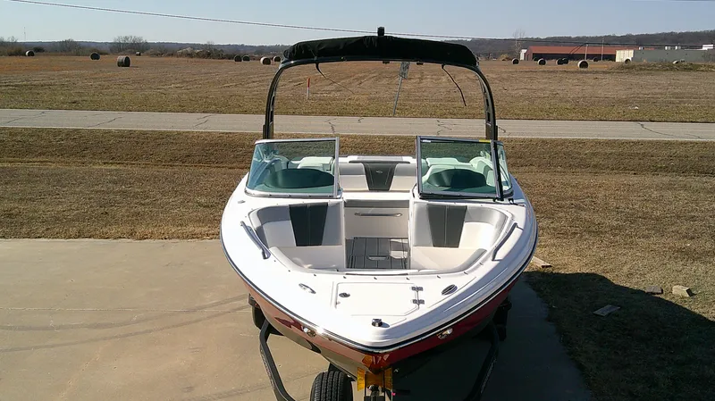 Slide: The Image of 2024 Chaparral 23 SSI SPORT boat on trailer, parked outdoors. - 3