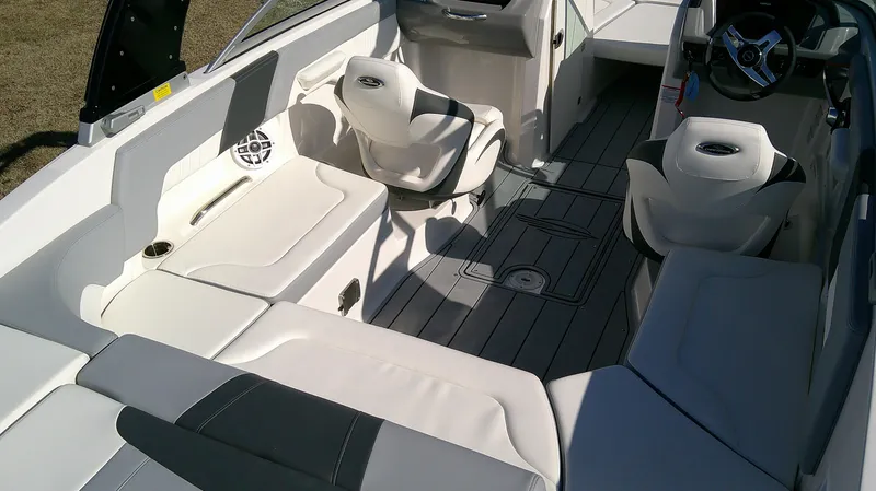 Slide: The Image of 2024 Chaparral 23 SSI SPORT boat interior with white seating and modern design. - 6