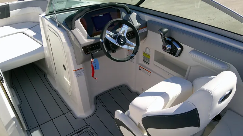 Slide: The Image of 2024 Chaparral 23 SSI SPORT boat interior with steering wheel and seating. - 7