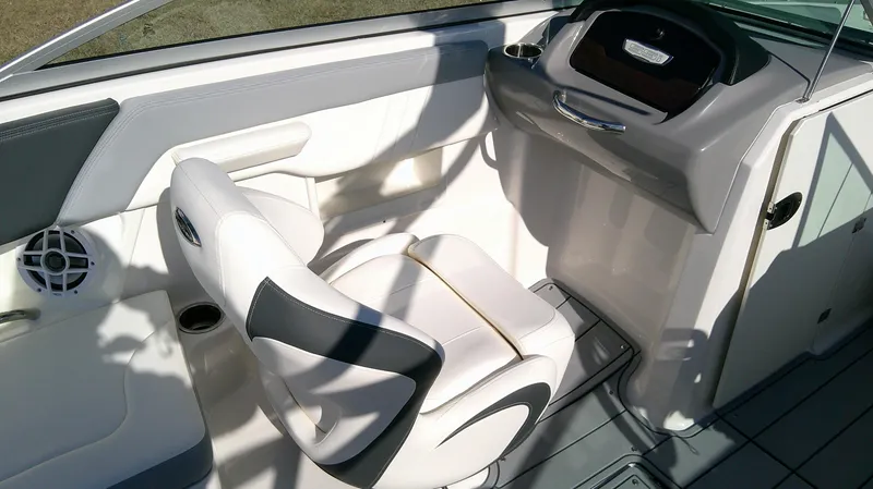Slide: The Image of 2024 Chaparral 23 SSI SPORT boat interior with white seating and dashboard. - 9