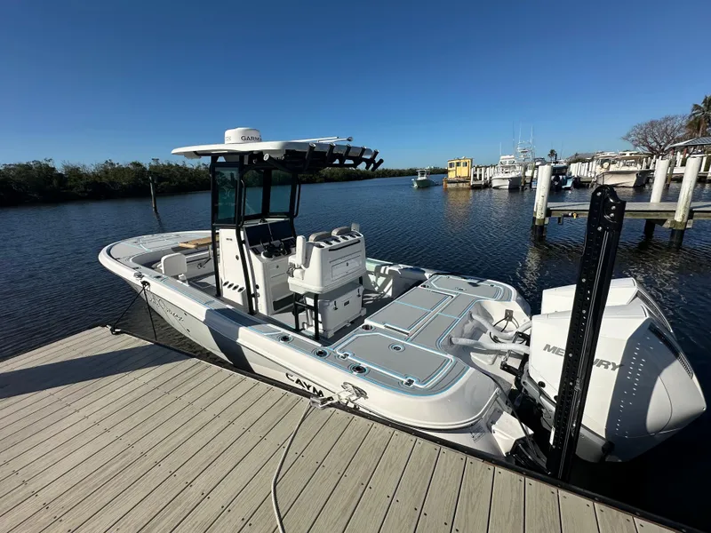 Slide: The Image of 2024 Caymas 281 HB boat docked by the water, featuring a sleek design and modern equipment. - 1