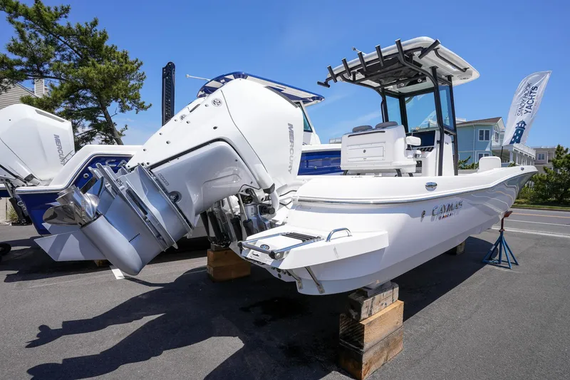 Slide: The Image of 2024 Caymas 281 HB boat on display with dual outboard engines. - 13