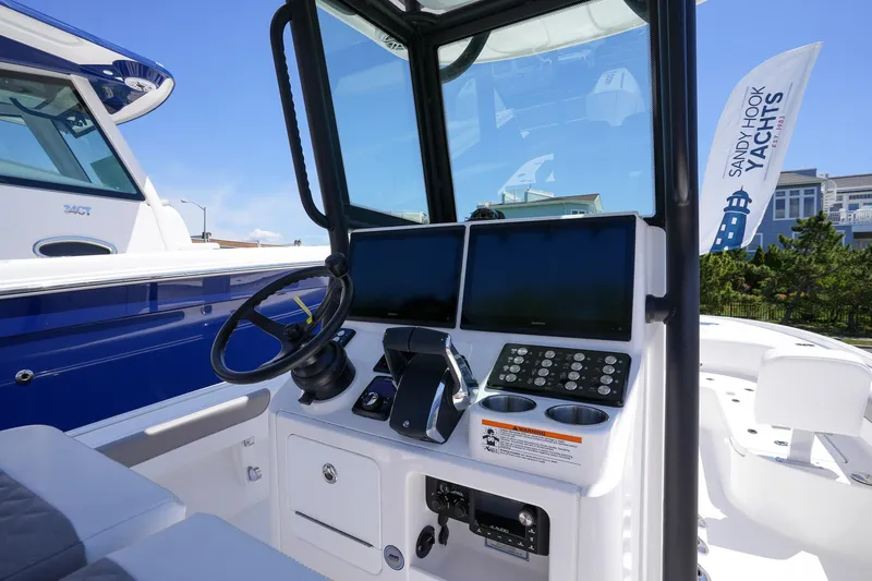 Slide: The Image of 2024 Caymas 281 HB boat helm with dual screens and steering wheel. - 18