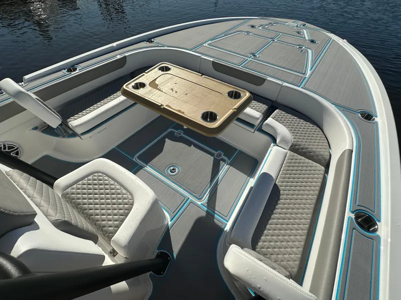 Slide: The Image of 2024 Caymas 281 HB boat interior with seating and table on calm water. - 2