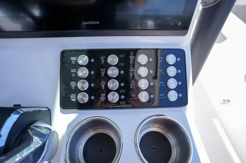 Slide: The Image of Control panel of 2024 Caymas 281 HB boat with Garmin display and cup holders. - 20